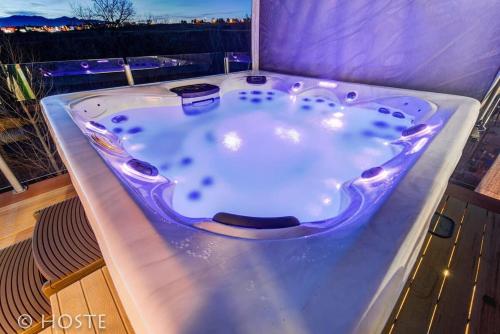 a jacuzzi tub sitting on top of a balcony at *H* 5BR Home Getaway w/HOT TUB ** in Pikeview