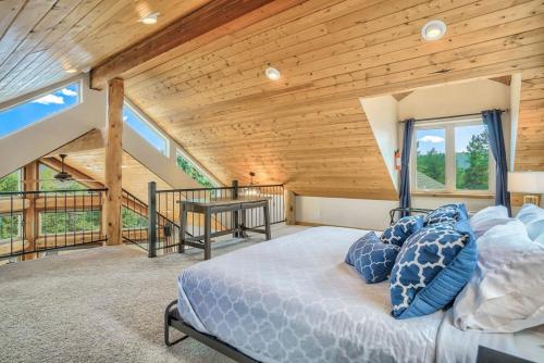 a bedroom with a bed and a wooden ceiling at 5BR Family Mountain Cabin Hot Tub & Gaming Garage in Woodland Park