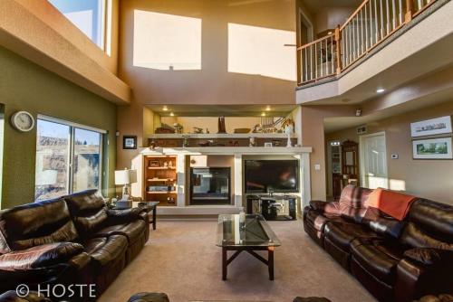 a living room with leather couches and a tv at *H* 5BR Home Getaway w/HOT TUB ** in Pikeview