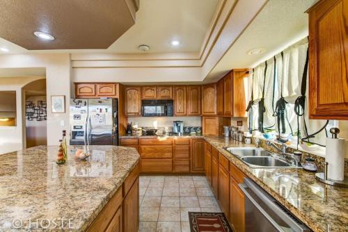 a large kitchen with wooden cabinets and granite counter tops at *H* 5BR Home Getaway w/HOT TUB ** in Pikeview
