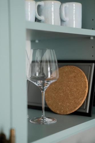 a glass of wine sitting next to a cookie at Bob W Lübeck Old Town in Lübeck