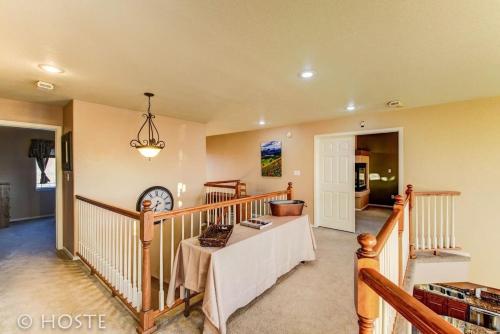 a room with a staircase with a table in it at *H* 5BR Home Getaway w/HOT TUB ** in Pikeview