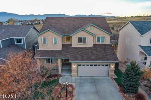 a house with a driveway and a garage at *H* 5BR Home Getaway w/HOT TUB ** in Pikeview
