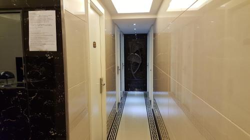 a hallway in a building with a long hallway at Seasons Hotel - Causeway Bay in Hong Kong