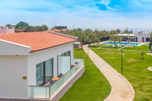 a balcony of a house with a view of a park at Assos Altın Hotel in Behramkale
