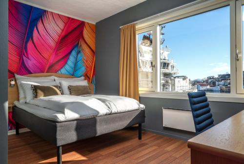 a bedroom with a bed and a large window at Thon PartnerHotel Storgata in Kristiansund