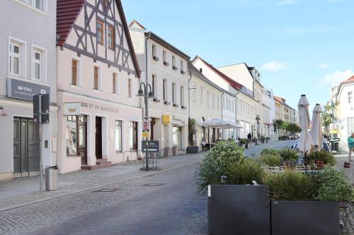 a cobblestone street in a town with buildings at reoh I Maisonette am See I Malerischer Ausblick I Beamer I Berlin in 30min in Strausberg