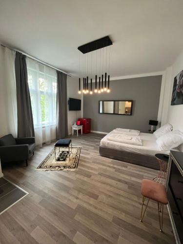 a bedroom with a bed and a living room at King David Garden in Berlin