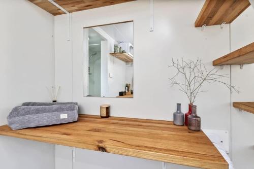 a bathroom with a wooden counter with a mirror at Azaltie in Kangaroo Valley