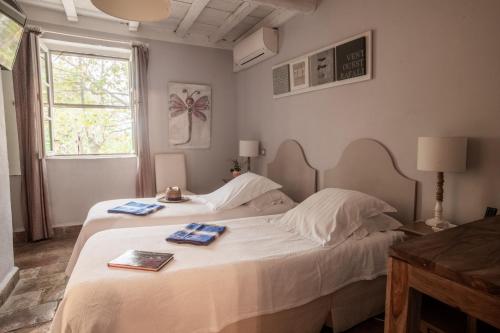 a bedroom with a bed with two towels on it at HOTEL et APPARTEMENTS DOMAINE DES CLOS - Teritoria in Beaucaire