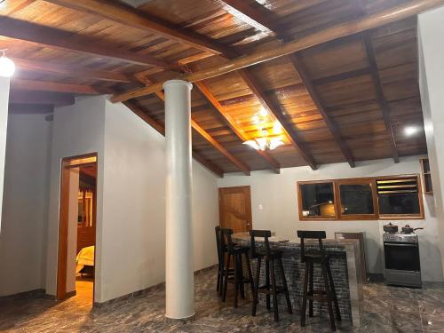 a dining room with a table and chairs and a pole at Casa SAMAY OLLANTAYTAMBO in Ollantaytambo