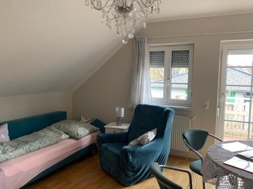a bedroom with a bed and a chair and a table at Ferienhaus Loretto in Wölzing