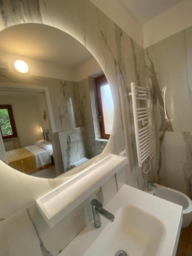 a bathroom with a sink and a mirror at Pi.Lù. Bed and breakfast in Borgo