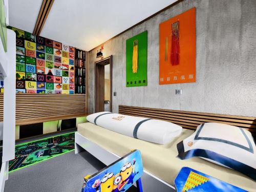 a bedroom with two beds and a chair at Hotel Rössle in Dobel