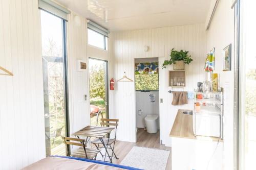 a kitchen with a table and chairs in a room at Tiny Balloon House in Canowindra