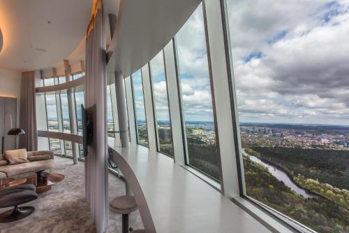 a living room with large windows and a couch at Vilnius TV Tower Apartments DEBESYS in Vilnius