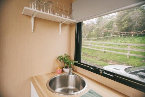 a sink in a bathroom with a window at Rose Hill in Neerim South