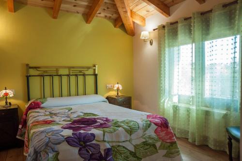 a bedroom with a bed and a large window at Los Robles 2 in Soria