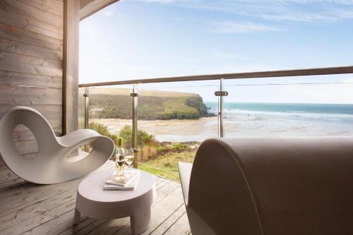 a bedroom with a view of the ocean and a tub at Scarlet Hotel - Adults Only in Mawgan Porth