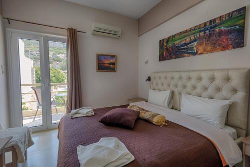 a bedroom with a large bed with a large window at Fantastic Matala 1 in Matala