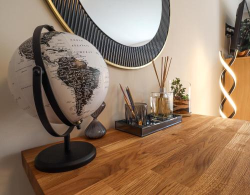 a globe on top of a wooden table at Spacious APT Romantic Getaway in Eastbourne