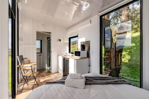 a bedroom with a bed and a large window at Montara Views 1 in Ararat