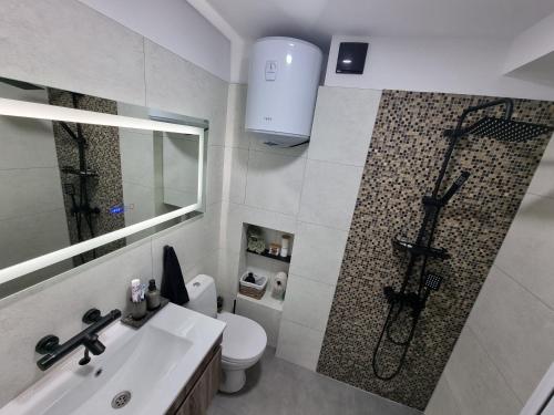 a bathroom with a shower and a toilet and a sink at MI 5 in Ruse