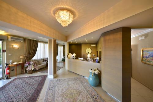 a hallway with a living room with a couch at Hotel Villa Tiziana in Marina di Massa