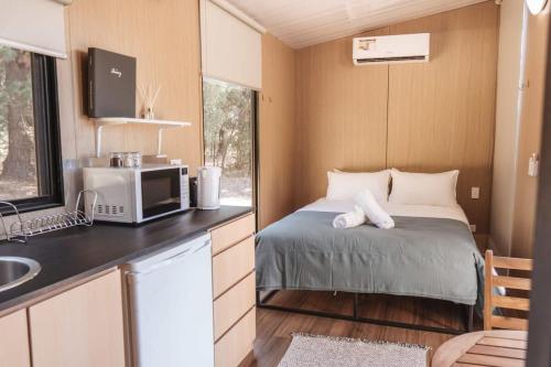 a small bedroom with a bed and a sink at Wally's Retreat 1 in Balingup