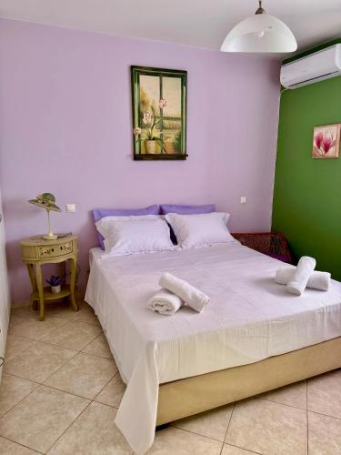 a bedroom with a large bed with towels on it at Villa Korina in Posidhonía