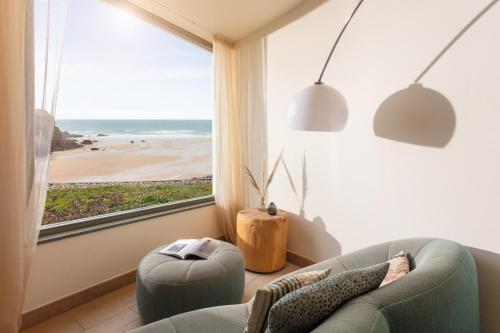 a living room with a view of the beach at Scarlet Hotel - Adults Only in Mawgan Porth