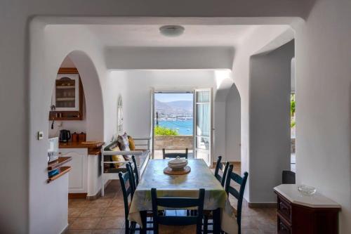 a kitchen and dining room with a table and chairs at Parikia Cove Mansion in Parikia