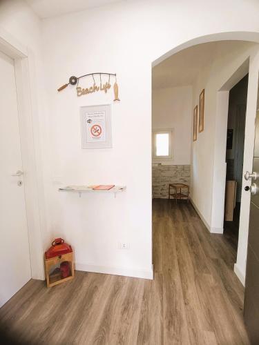 a hallway with white walls and a wooden floor at Rachele Guest House La Spezia in La Spezia