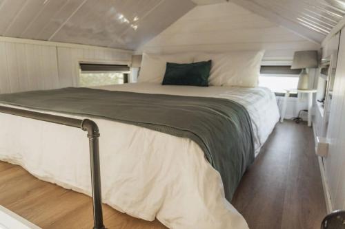 a bedroom in a tiny house with a large bed at Mary Valley Views in Amamoor