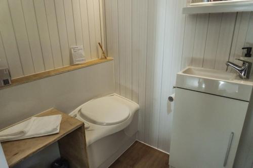 a small bathroom with a toilet and a sink at Mary Valley Views in Amamoor
