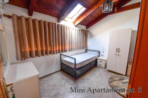 a small room with a bed and a window at Kultura Hostel in Shkodër