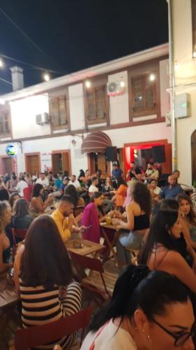 a crowd of people sitting at tables in a room at Kultura Hostel in Shkodër