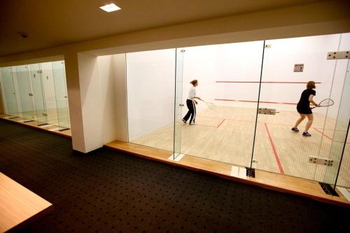 two people playing a game of tennis on a court at Hotel Ponteo - Activity Park in Bratislava