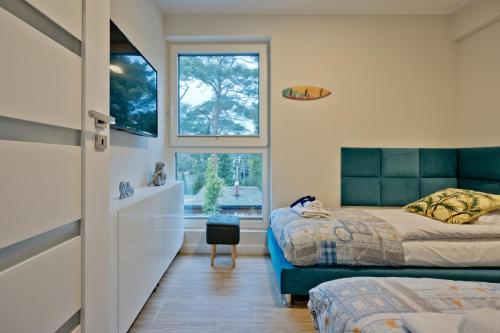 Ένα ή περισσότερα κρεβάτια σε δωμάτιο στο BlueApart Apartamenty Jurata