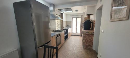 eine Küche mit einem Kühlschrank und einem Herd Top-Backofen in der Unterkunft Chez Philippe et Agnès in Vauciennes