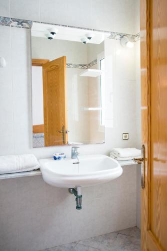 a bathroom with a white sink and a mirror at Apartchalet villas Elvira. Villa E in Son Carrio