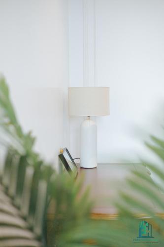 a lamp sitting on a table in a room at Luxe Paradise Suite Hotel Trich Sai in Hanoi