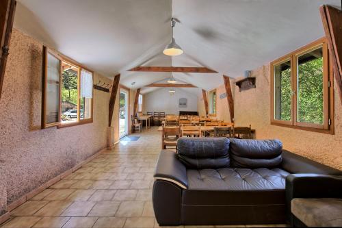 a living room with a couch and a table at Gite Skioura, Gite De Groupe in Superbagnères