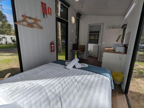 a bedroom with a bed in a tiny house at Tiny House 4 at Grampians Edge in Dadswells Bridge