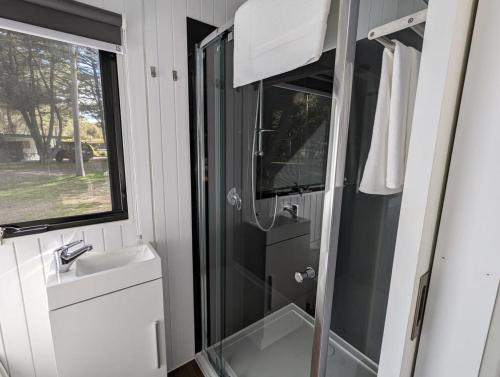 a bathroom with a shower and a sink at Tiny House 4 at Grampians Edge in Dadswells Bridge