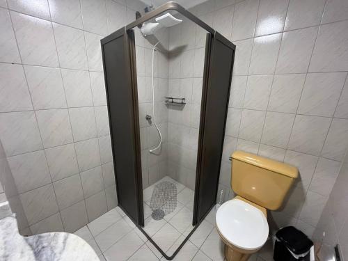 a bathroom with a shower with a toilet in it at Studio Grenal - JK Bem Localizado in Porto Alegre