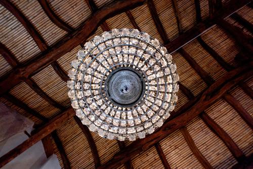 a chandelier hanging from a wooden ceiling at Palazzo Boyl 1840 in Cagliari