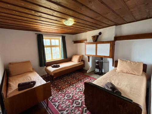 a bedroom with two beds and a couch in it at Spring House Изворна Къща 