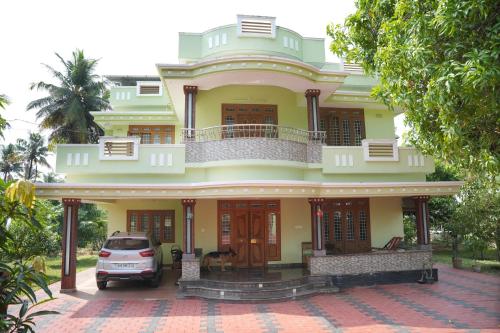 a car parked in front of a house at Ashiaana Homestay in Trichūr