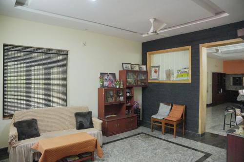 a living room with a couch and a chair at Ashiaana Homestay in Trichūr